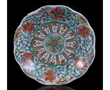 Porcelain Doucai dish with contoured rim, lotus and orchid decoration applied in blue underglaze and red, blue and yellow ena