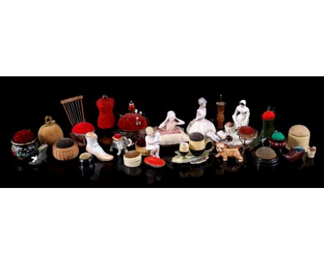 26 pieces of sewing kit pincushions of different materials incl. porcelain, brass, wood and silver plated, with documentation