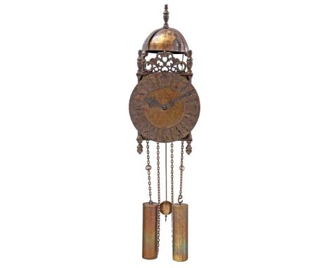 Brass lantern clock after an antique model on a wooden plate with a decoration of life and death, 55 cm high