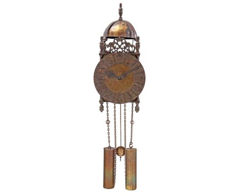 Brass lantern clock after an antique model on a wooden plate with a decoration of life and death, 55 cm high