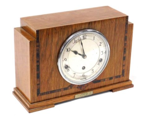 An Art Deco oak and rosewood crossbanded mantel clock, circular silvered dial with chapter ring bearing Arabic numerals, Garr
