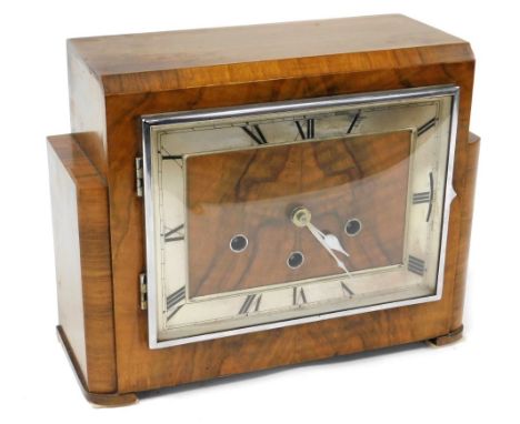 An Art Deco walnut cased mantel clock, with silvered rectangular chapter ring bearing Roman numerals, eight day German moveme