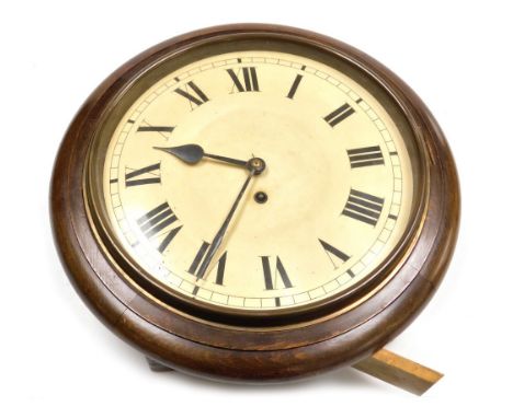 A 19thC oak cased railway clock, the cream enamel dial bearing Roman numerals, thirty hour, single barrel movement, 40cm diam