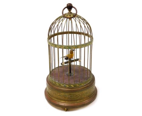 An early 20thC musical bird cage automaton, with a canary on a pole, clockwork movement, 29cm high.