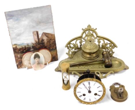 A late 19thC brass desk stand, embossed with scrolling leaves, together with a late 19thC French clock movement, antique padl
