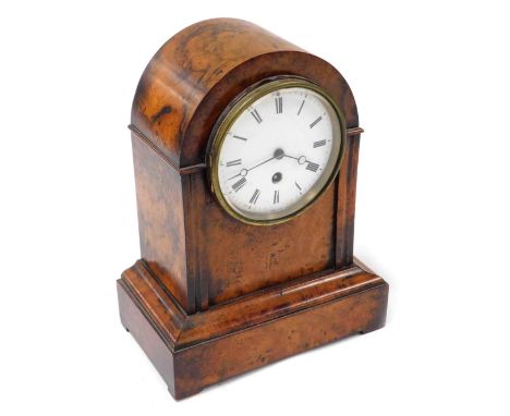A Victorian walnut cased mantel clock, circular enamel dial bearing Roman numerals, thirty hour movement, stamped VM, the cas