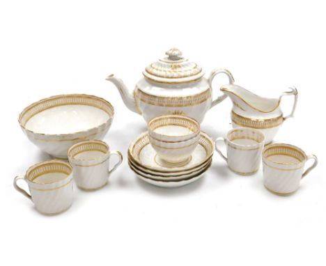 An early 19thC Newhall porcelain part tea service, decorated in gilt against a white ground, comprising teapot, milk jug, slo