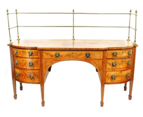 A George III flame mahogany break front sideboard, with brass curtain rail to the top and curved cross banded borders, with c