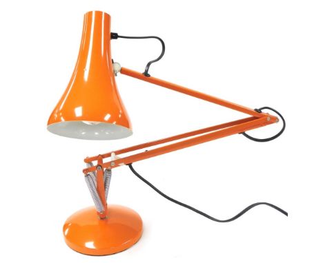 An orange Anglepoise type lamp, 86cm high. 