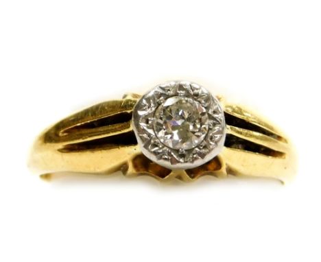 An 18ct gold and diamond solitaire ring, in a claw setting with channelled shoulders, approximately ¼ct, size Q, 4.9g.