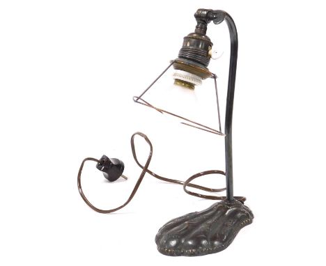 An early 20thC Continental copper base desk lamp, embossed with stylised peacocks and flowers, with a Bakelite two pin plug, 