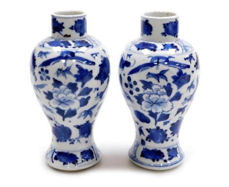 A pair of Qing dynasty blue and white baluster vases, hand painted with flower heads and birds, with underglaze blue four cha