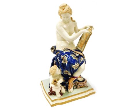 A Worcester majolica figure group, circa 1870, modelled as Venus seated with a picture, her right foot resting on a stool, wi