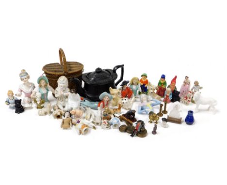 A group of collectables, to include porcelain pincushion dolls, various sizes and attires, a Jackfield type black pottery Bur