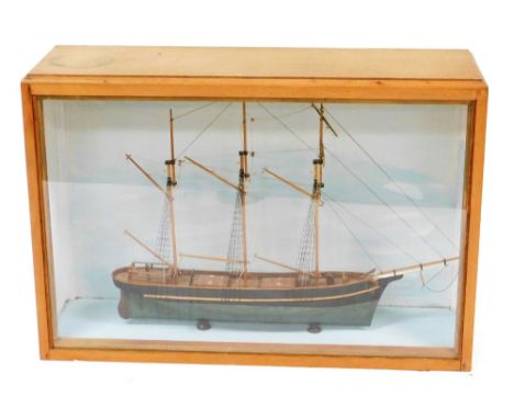 A wooden scale model of a barque sailing vessel, contained in a Perspex fronted oak display case, case 63cm high, 91cm wide, 
