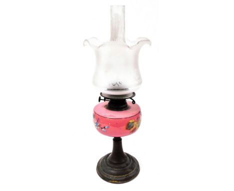 A late 19thC brass and pink glass oil lamp, the glass reservoir painted with flowers, with chimney and a frosted and etched g