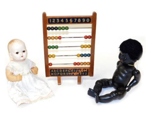 A vintage Chad Valley abacus, 39cm high, together with a Rosebud black composition doll, and a mid century celluloid doll.  (