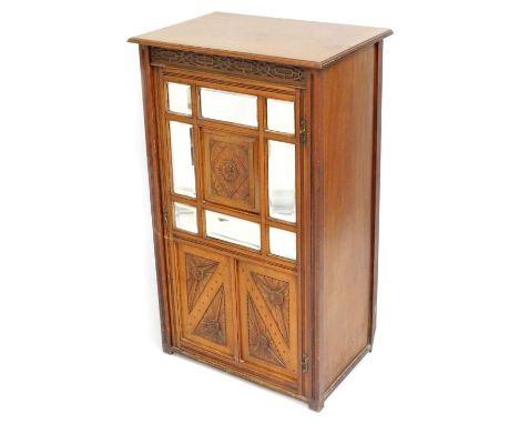 A Victorian oak cabinet, the top with a moulded edge above a carved panel and glazed door, 97cm high, 55cm wide, 38cm deep.