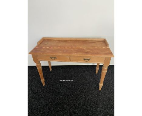 A 19th century pine two drawer console table. Designed on turned legs 