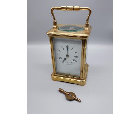 A Heavy Antique brass and bevel glass carriage clock. Comes with a key. [Runs for a short while then stops, Has a nice chime]