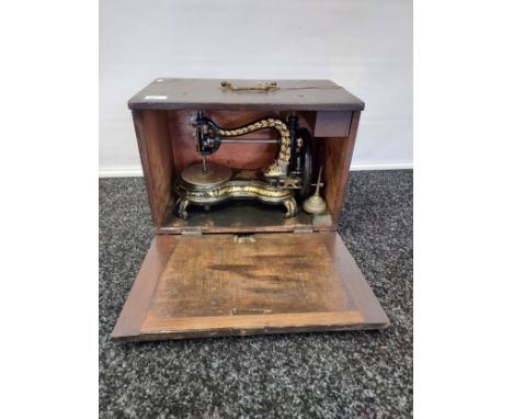 A Rare 19th century Jones Sewing Machine, The Wellington model has a flower decal on the bed. Comes with instructions, Tools 