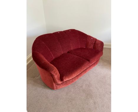 An Art Deco two seat sofa upholstered in a red material 