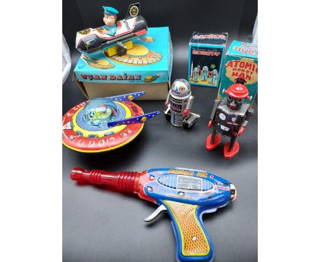 A Collection of various vintage tin plate clockwork space models. To include Shudo Astroray gun, Atomic Robot Man,Robot-7, Yo