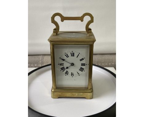 Antique heavy brass carriage clock [makers name unreadable] in a working order with double drum movement and together with ke