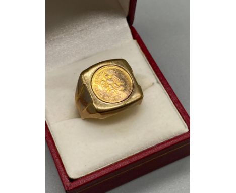 A Gent's 9ct gold ring set with a 1945 Mexican 2 Pesos Gold Coin. [Ring size T] [7.00grams] 