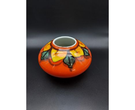 A Poole pottery bulbous orange glaze vase. [10cm in height] 