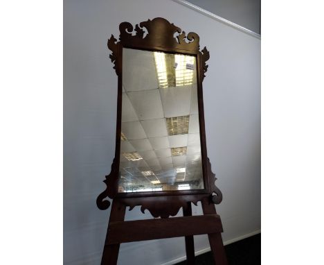 A Georgian mahogany framed mirror. In a Chippendale style, shaped crested top top and bottom [80cm in length] 