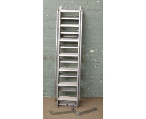 An alluminium extending loft ladder and brackets with hand rails.