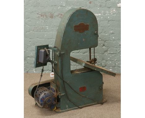 An electric motor driven Junior Whitehead tools band saw.
