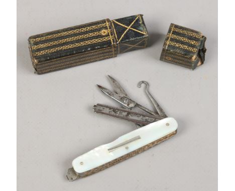 A multi tool folding pocket knife with worked back mother of pearl scales and in tooled leather box.