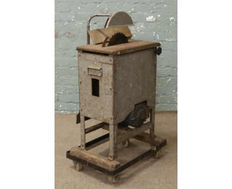 A vintage electric motor driven circualr saw.
