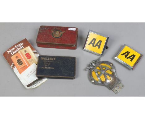 Three vintage AA car grill badges along with two cigarette advertising tins and a Dunhill tobacco sample.