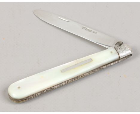 A Victorian silver folding fruit knife by Mappin Brothers. With mother of pearl scales. Assayed Sheffield 1892.