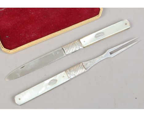 A Georgian silver folding knife and fork each with mother of pearl scales and worked backs. Partial hall marks with George II