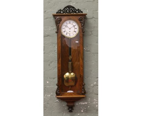 A 19th century walnut cased eight day Vienna wall clock white enamel and brass dial, pendulum, weight and key.