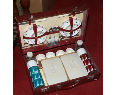 A vintage four place picnic set in a red vinyl carry case.