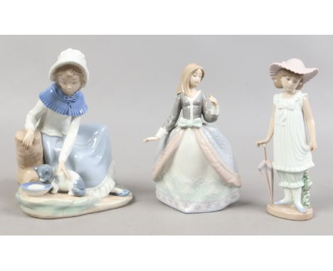 Two Nao figures of girls along with a similar Lladro figure. Condition Report. To be used as a guide only. Parasol missing.