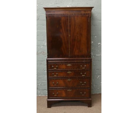 A Georgian style mahogany drinks cabinet. Crossbanded, with reeded corners and raised on bracket feet. 