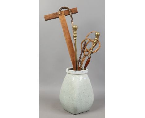 A crackle glazed pottery jar containing swagger stick, rug beater, set square and fire irons.