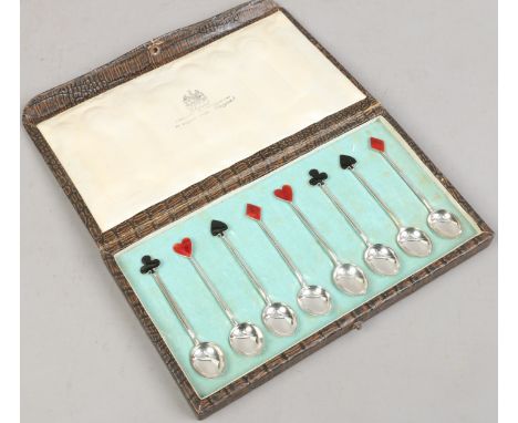 A cased set of eight silver playing cards themed demitasse spoons with enamel terminals, assayed Birmingham 1922, by Hukin & 