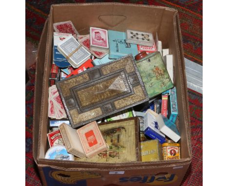 A box of advertising tins and playing cards.