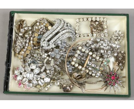 A box of vintage costume jewellery including white paste examples.