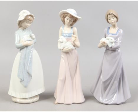 Three Nao figures of girls with animals. Condition Report. To be used as a guide only. One repaired.