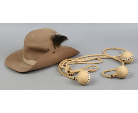 A Bolas three leg throwing / hunting rope along with a feathered wide brim hat.