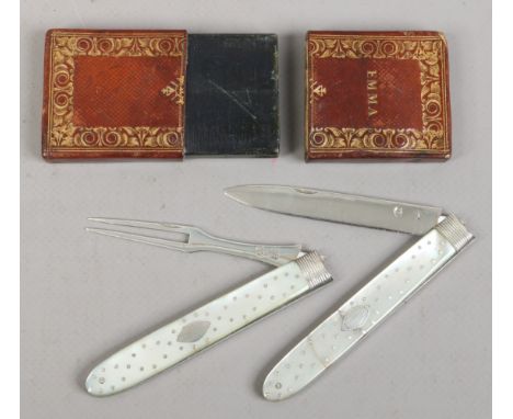 A Georgian silver folding fruit knife and fork set with mother of pearl scales having piquet inlay. In fitted tooled leather 