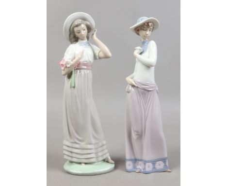 Two large Nao figures of ladies with flowers.